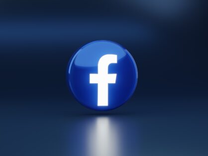glowng Facebook logo against dark blue background